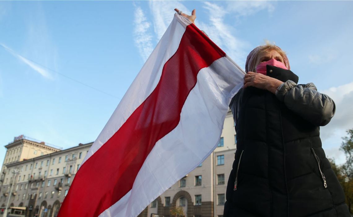 Protester waving flag in Minsk, Belarus