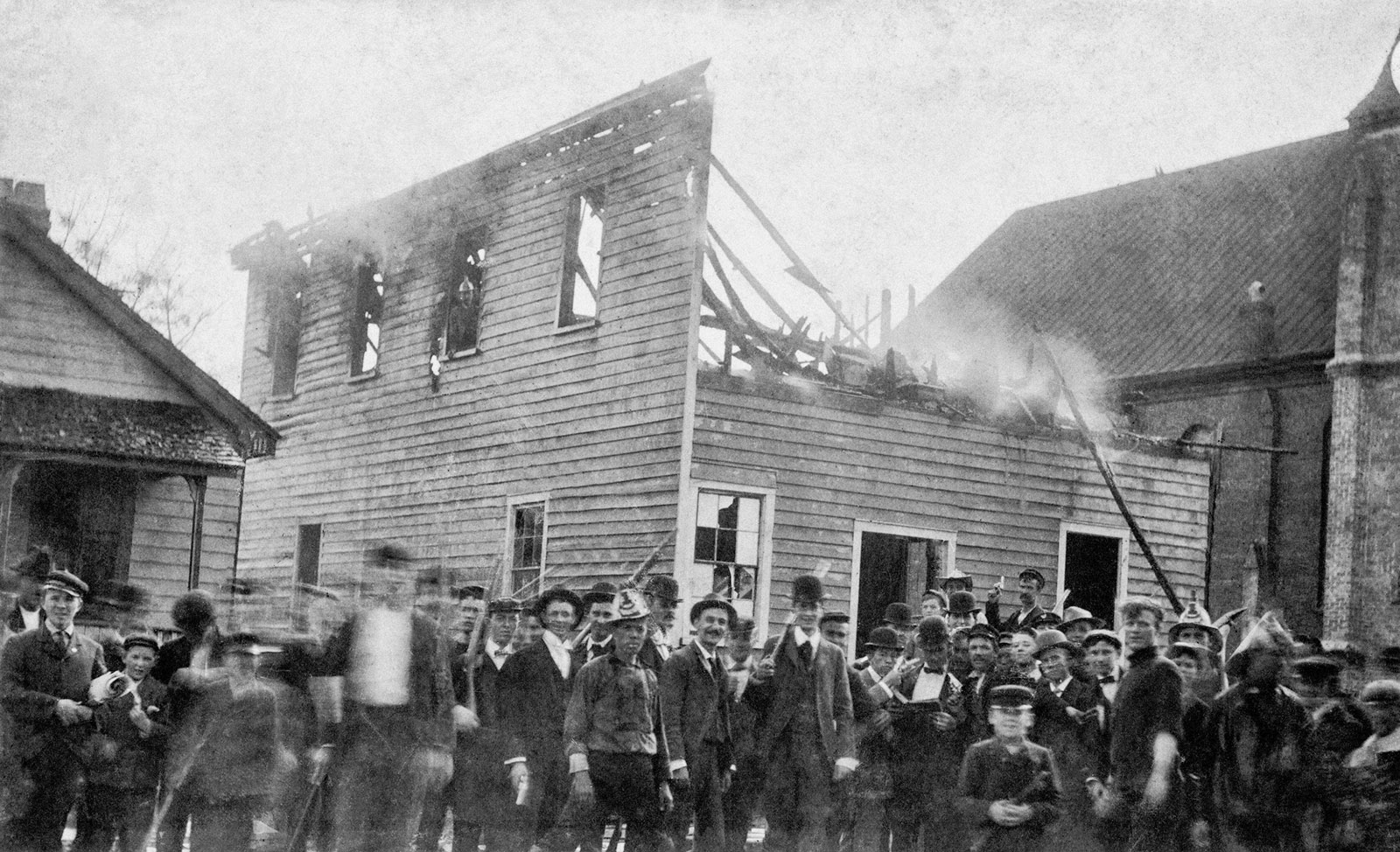 A mob of white men posing in front of the office of the black-owned Daily Record newspaper after burning it down, Wilmington, North Carolina, November 10, 1898