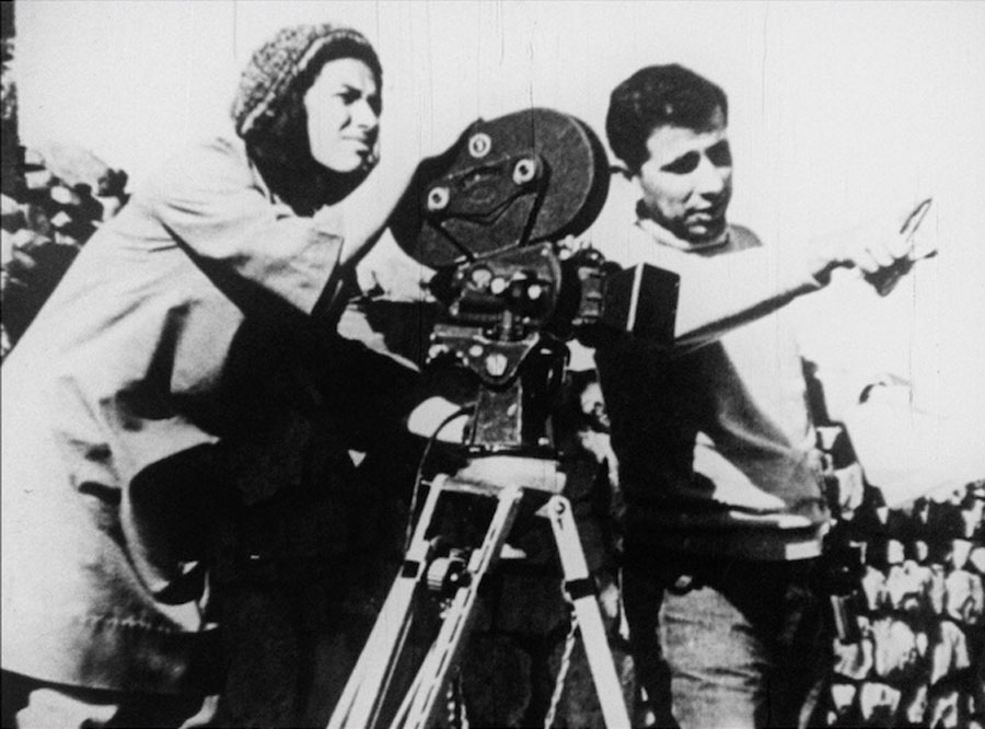 Sulafa Jadallah and Hani Jawherieh standing with a camera, circa 1970