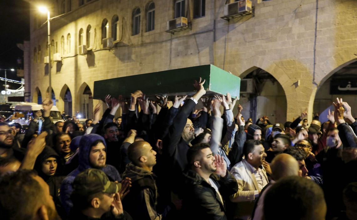 Angry Palestinian mourners carrying the coffin of Eyad al-Hallaq