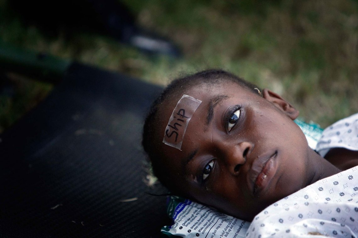 A little girl in Haiti waiting to be medivaced by US Army soldiers after the 2010 earthquake, an image that Christina Sharpe writes about in her book In The Wake