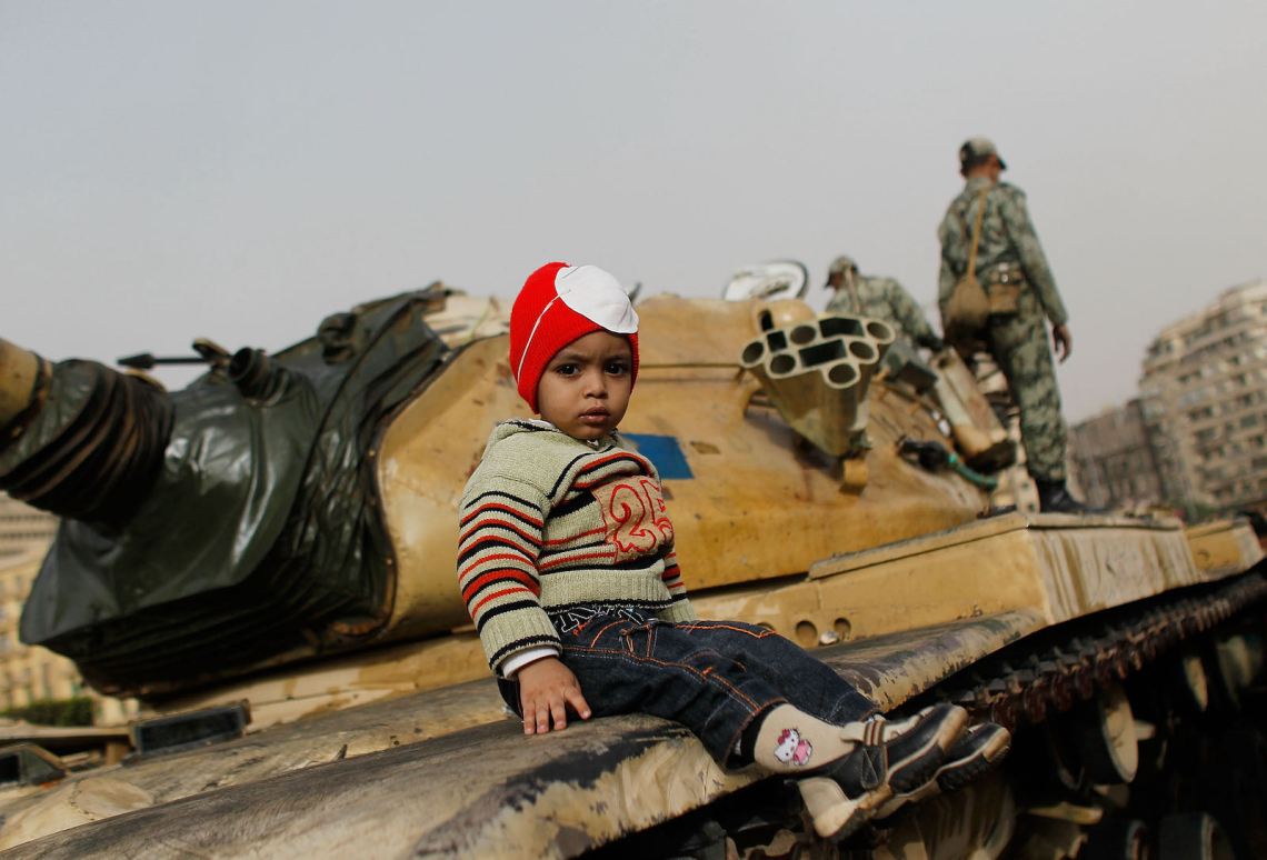 A child sitting on a tank