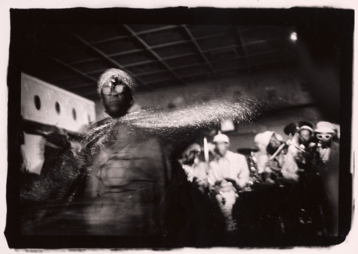 Sun Ra performing in club setting with musicians in background