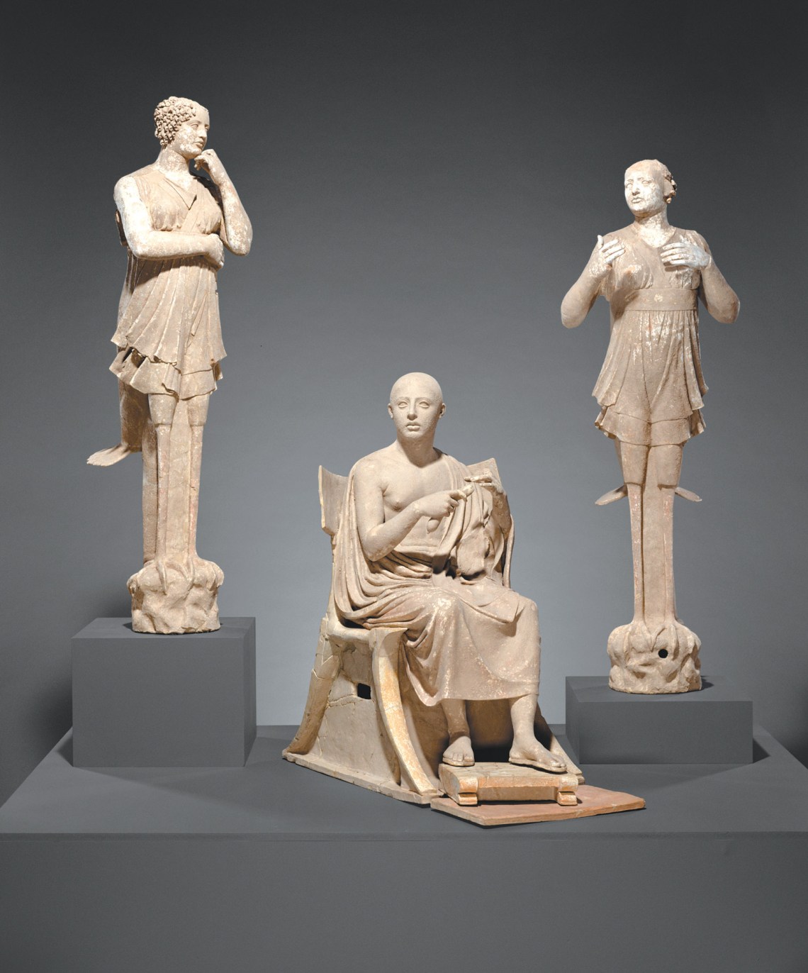 Terracotta sculptures of a seated poet and two sirens