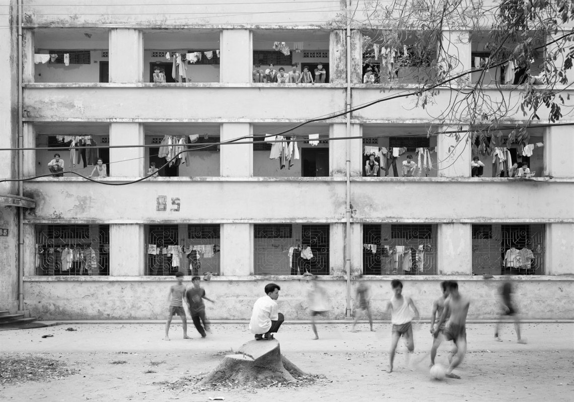Kids playing outside an apartment complex, in black and white