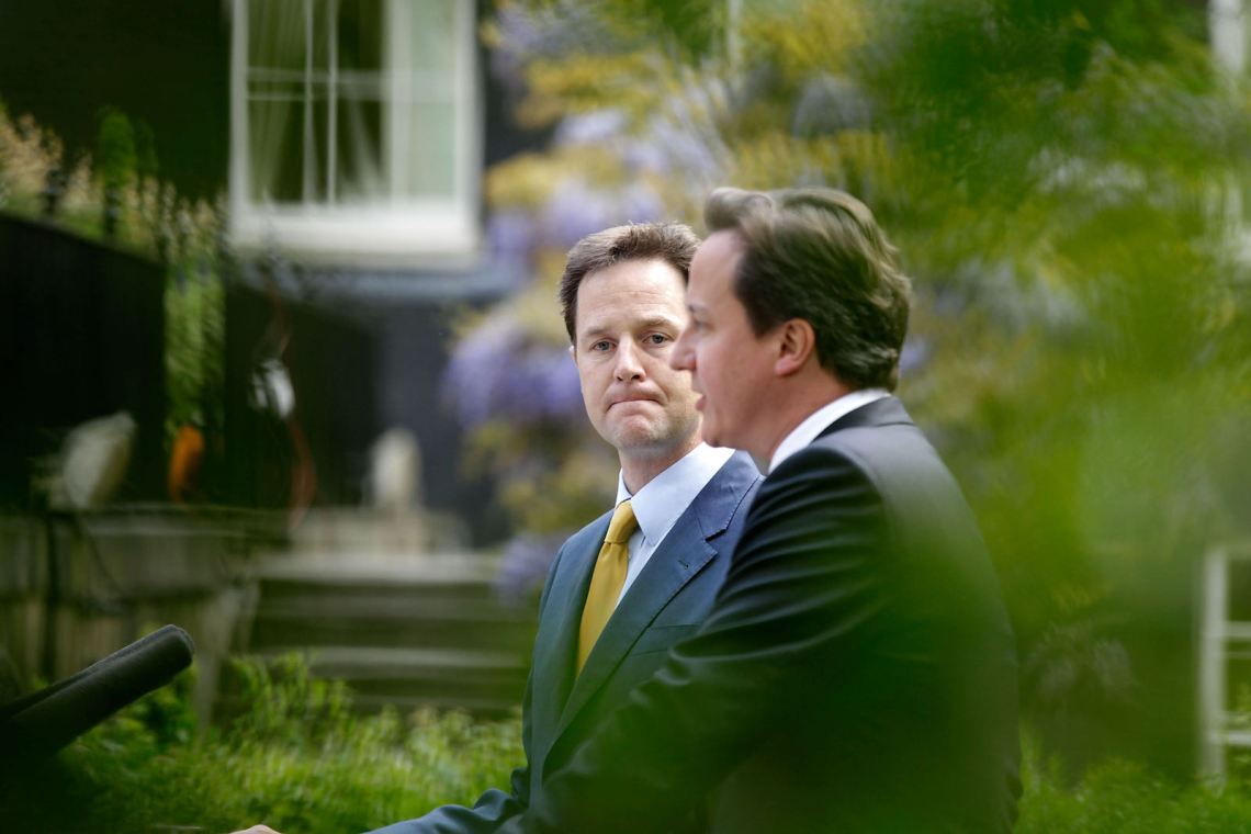 Deputy Prime Minister Nick Clegg looking on