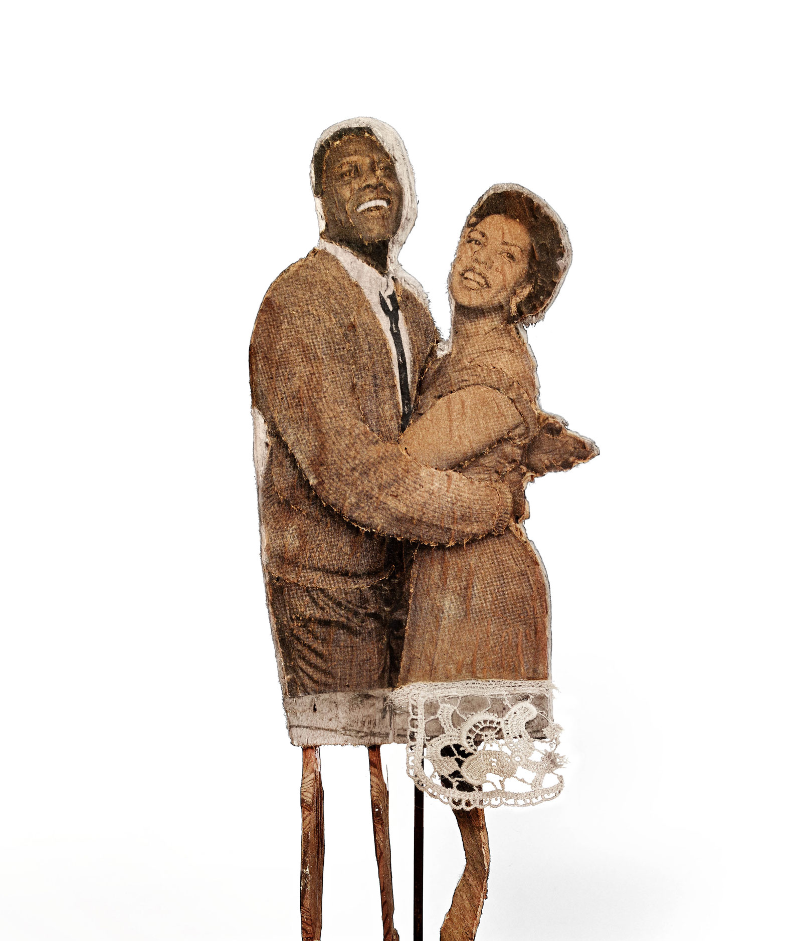 cut out figures of an African American couple holding each other and laughing, their legs sticks