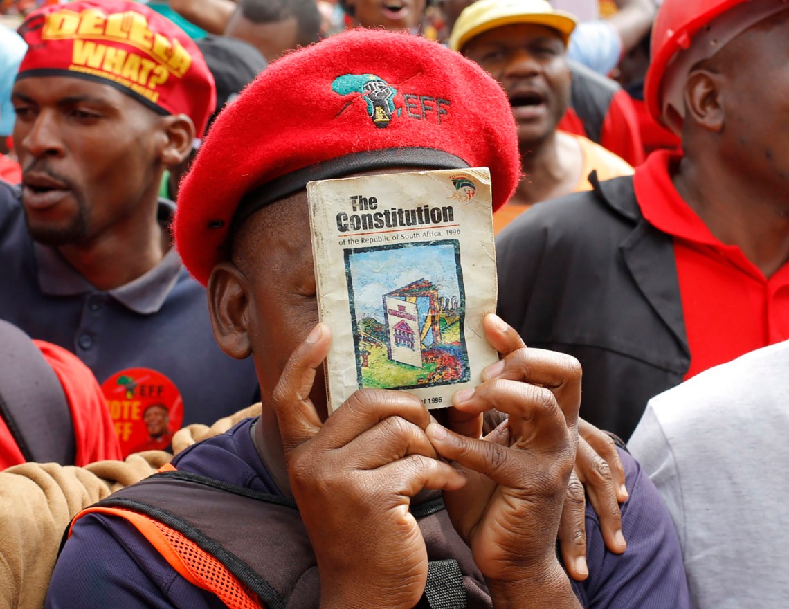 A protester holding a copy of South Africa’s Constitution
