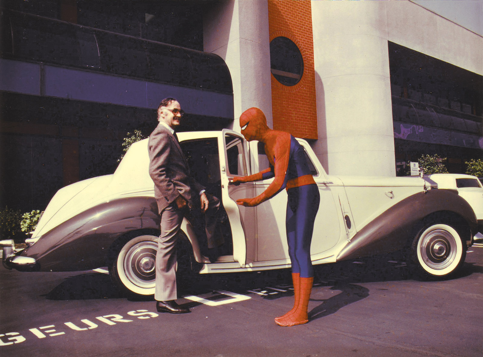 Stan Lee and a Marvel employee in Spider-man costume in the Marvel Productions parking lot
