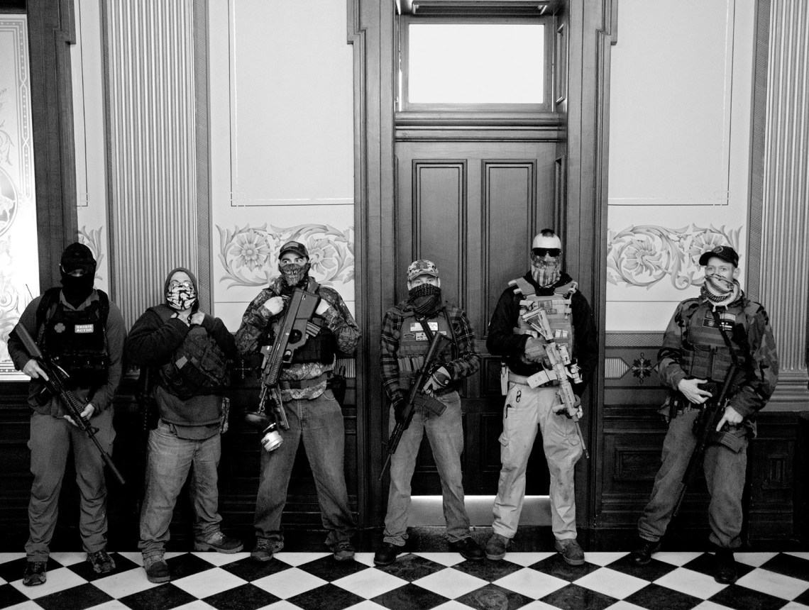 Members of a militia group outside the office of Michigan governor Gretchen Whitmer during a protest against her Covid stay-at-home order