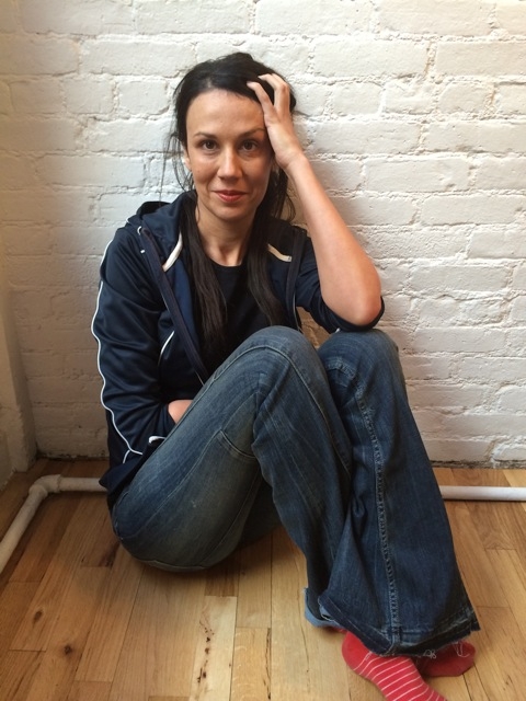Rivka Galchen sitting on the floor in socks