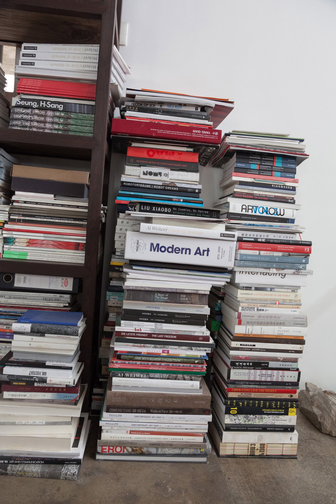 Stacked books in Ai Weiwei's living area