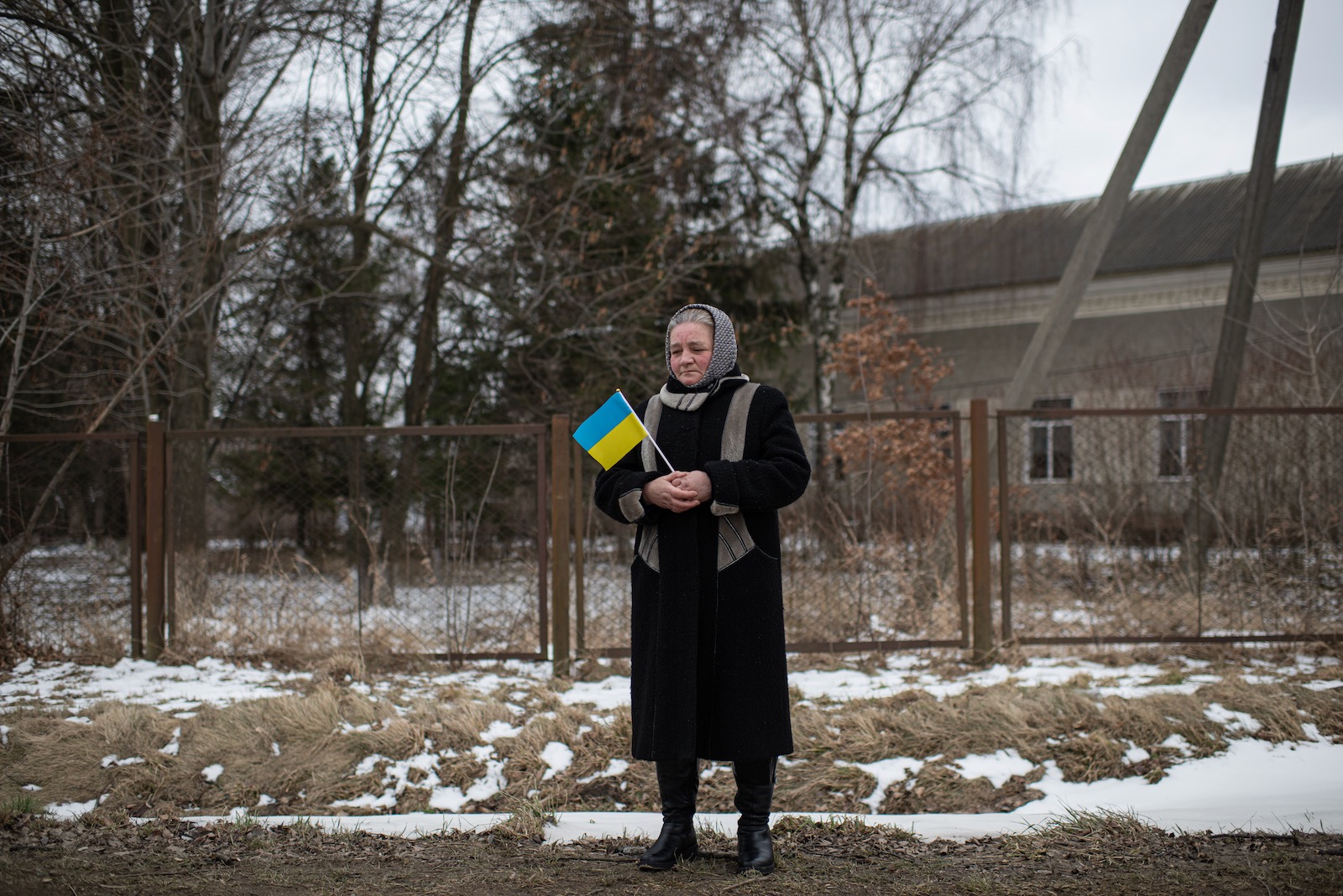 A woman holding a Ukrainian flag