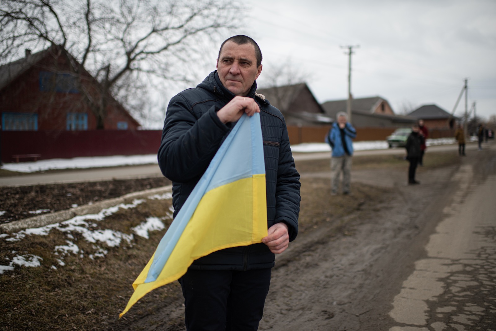 A man holding a Ukrainian flag