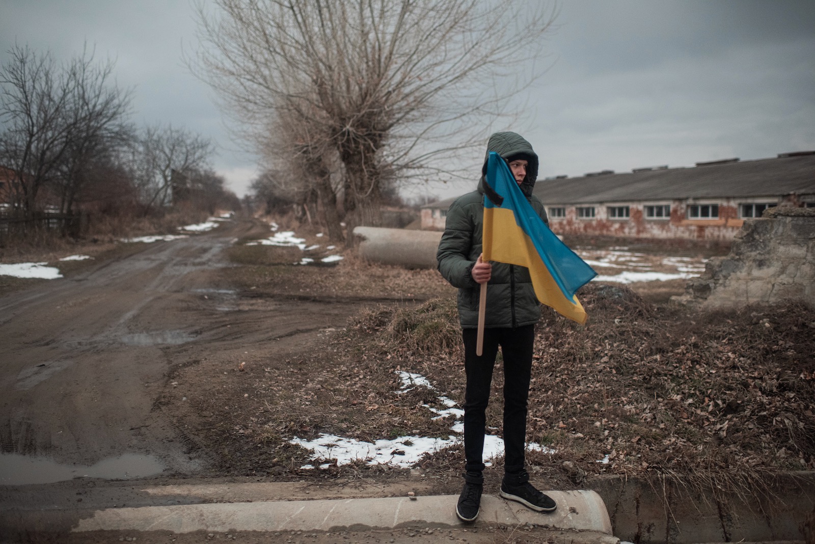 A boy holding a Ukrainian flag