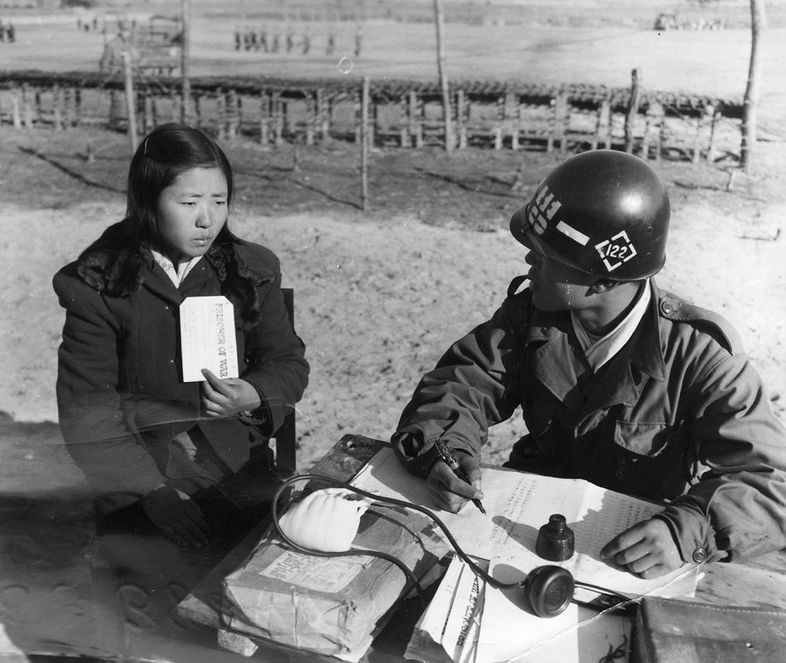 A young Communist woman being questioned by a soldier in a prisoner-of-war camp, Gurijae, South Korea