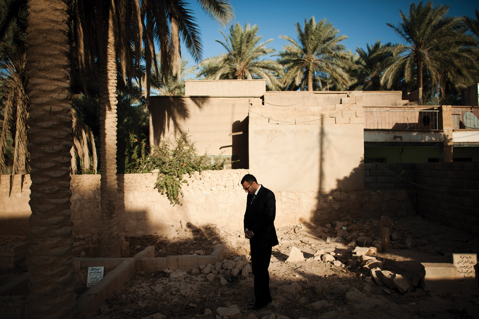 Khalid Salman by the graves of his sister and her children, who were among the twenty-four Iraqi civilians killed by US Marines in the 2005 Haditha massacre