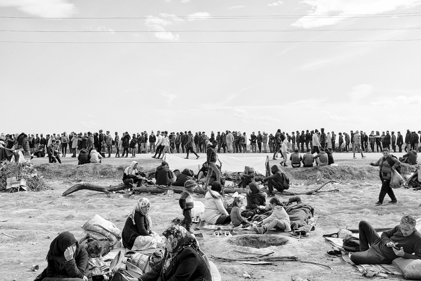 Syrian refugees waiting at the Pazarkule border gate between Turkey and Greece