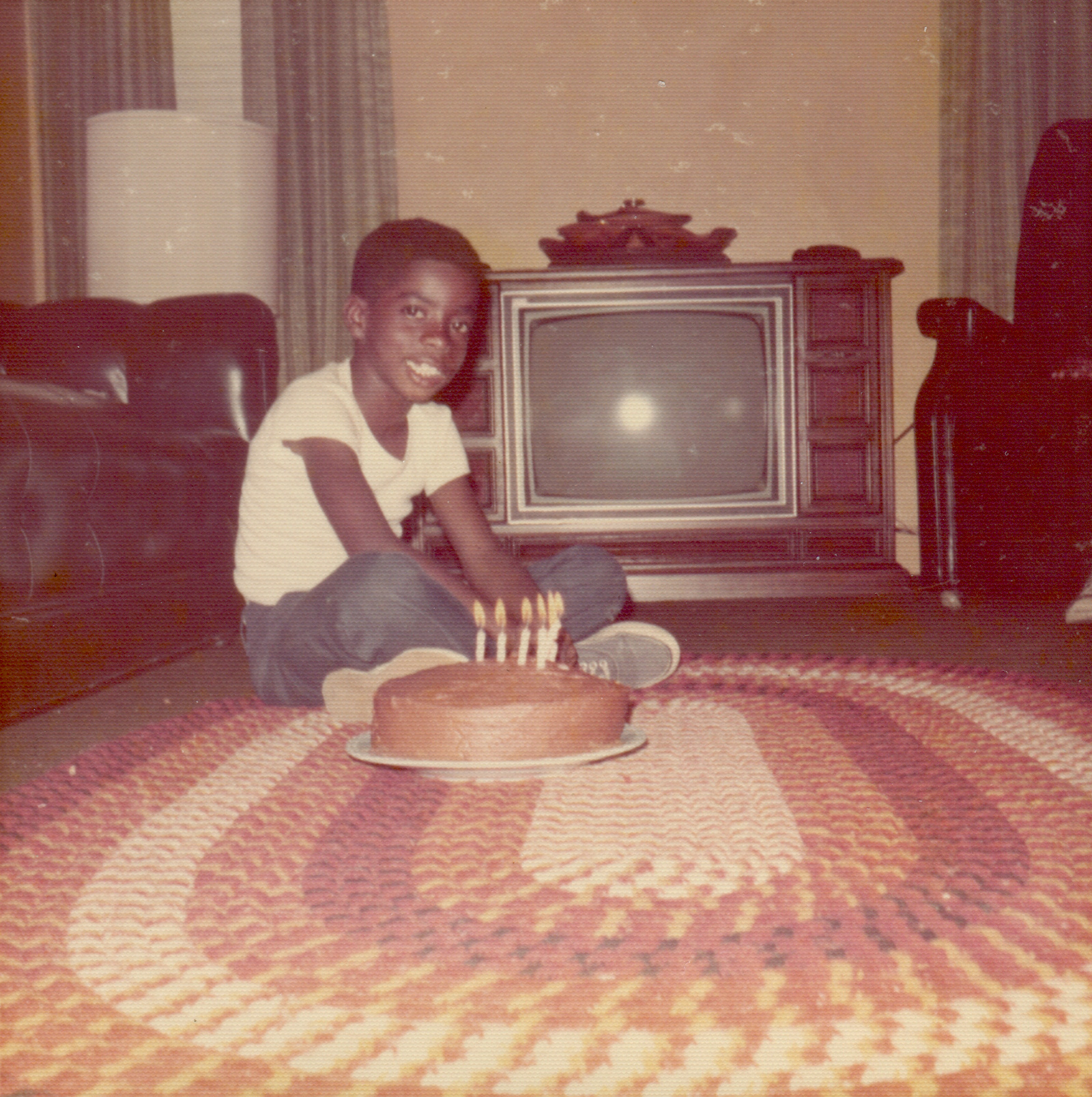 A young boy in front of a TV