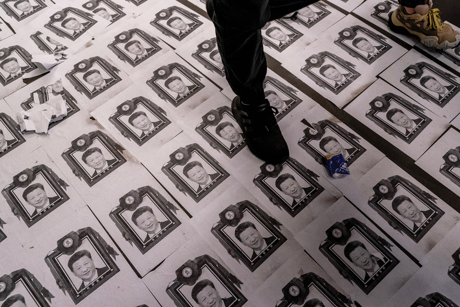 Protesters walking over images of Chinese leader Xi Jinping during pro-democracy demonstrations, Hong Kong