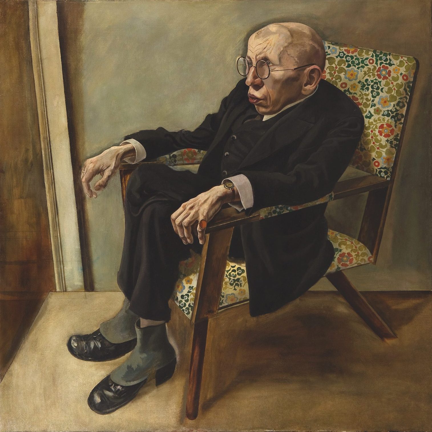 Portrait of an older man sitting in a floral chair