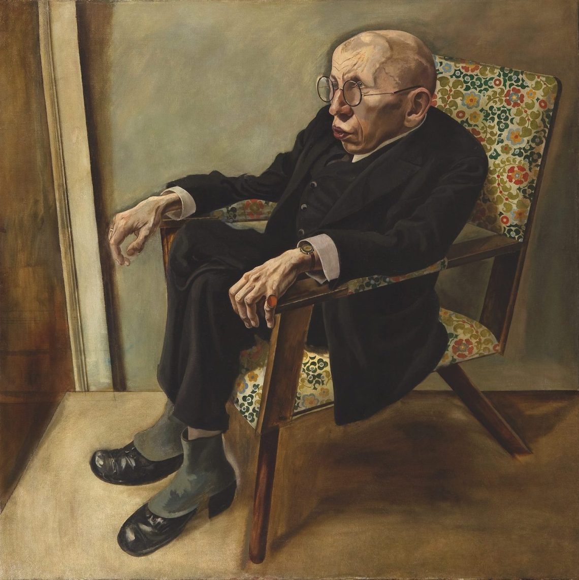 Portrait of an older man sitting in a floral chair