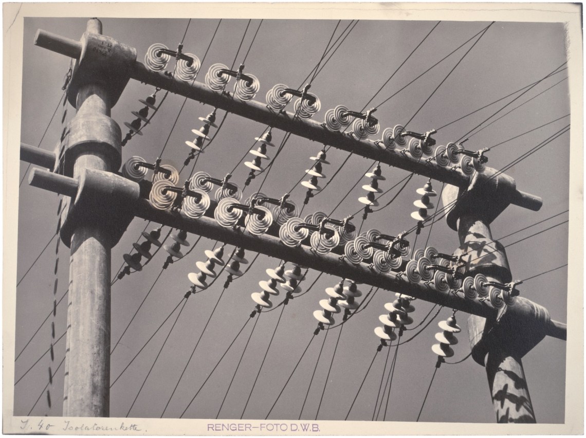 Black-and-white photograph of wire isolators on a telephone line