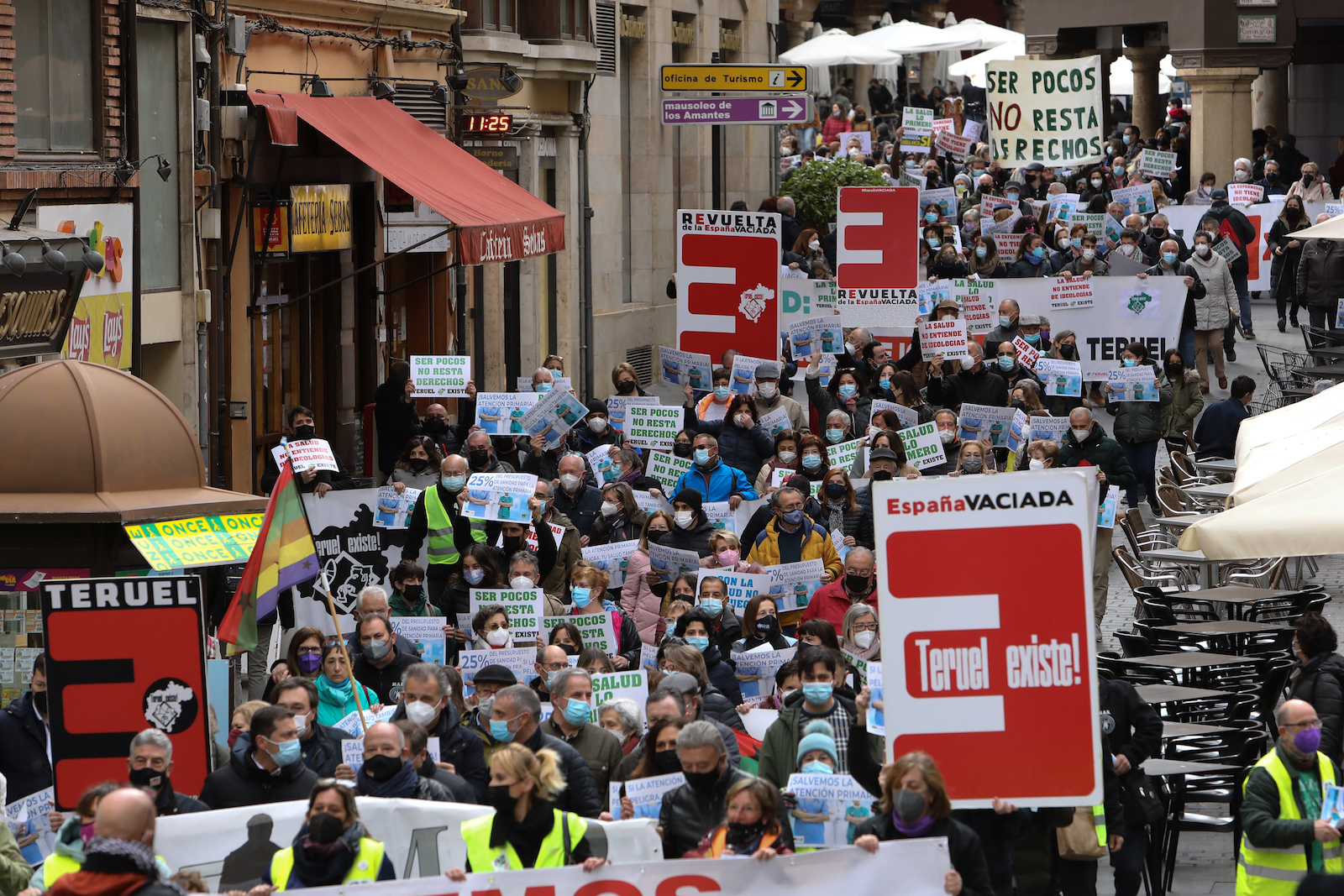 a street full of demonstrators hold signs for Empty Spain