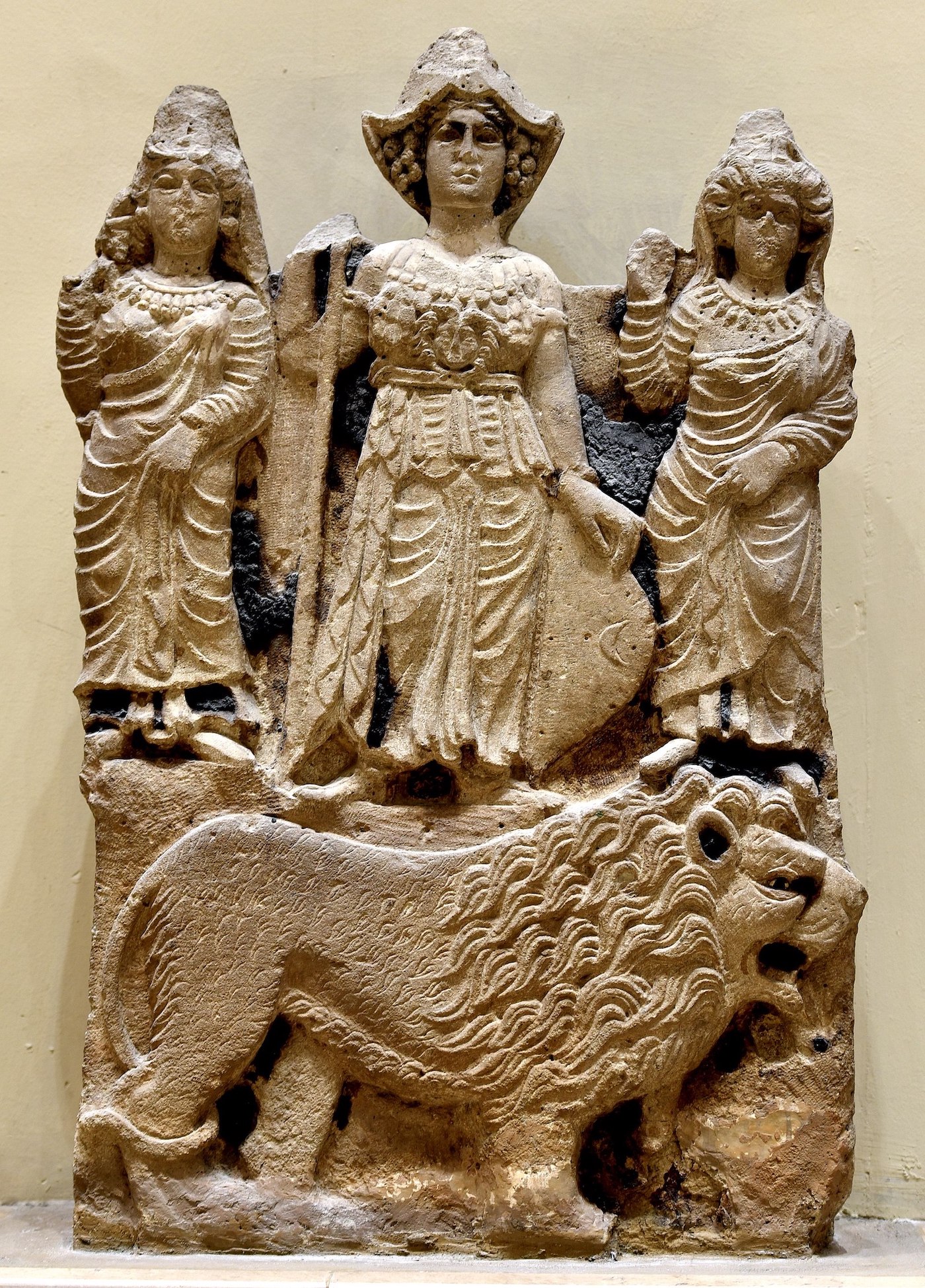 A carved relief of three women that may represent the pre-Islamic goddesses Manat, Allat, and al-Uzza