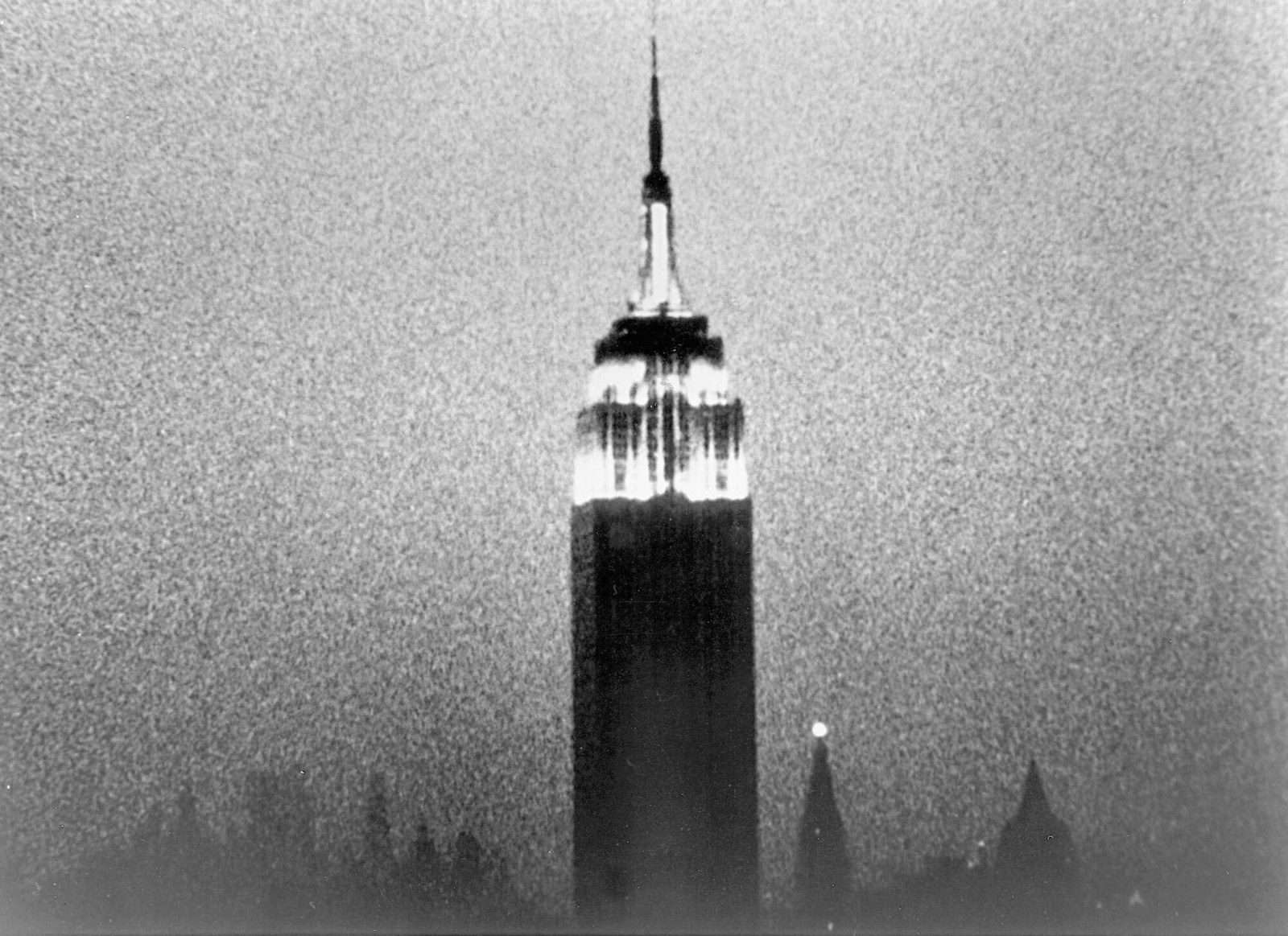 A still from a grainy black-and-white film of the Empire state building