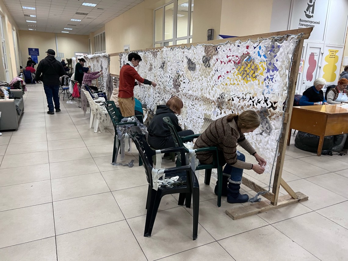 Volunteers making white winter webbing to camouflage bunkers, tanks and artillery, Odesa, Ukraine