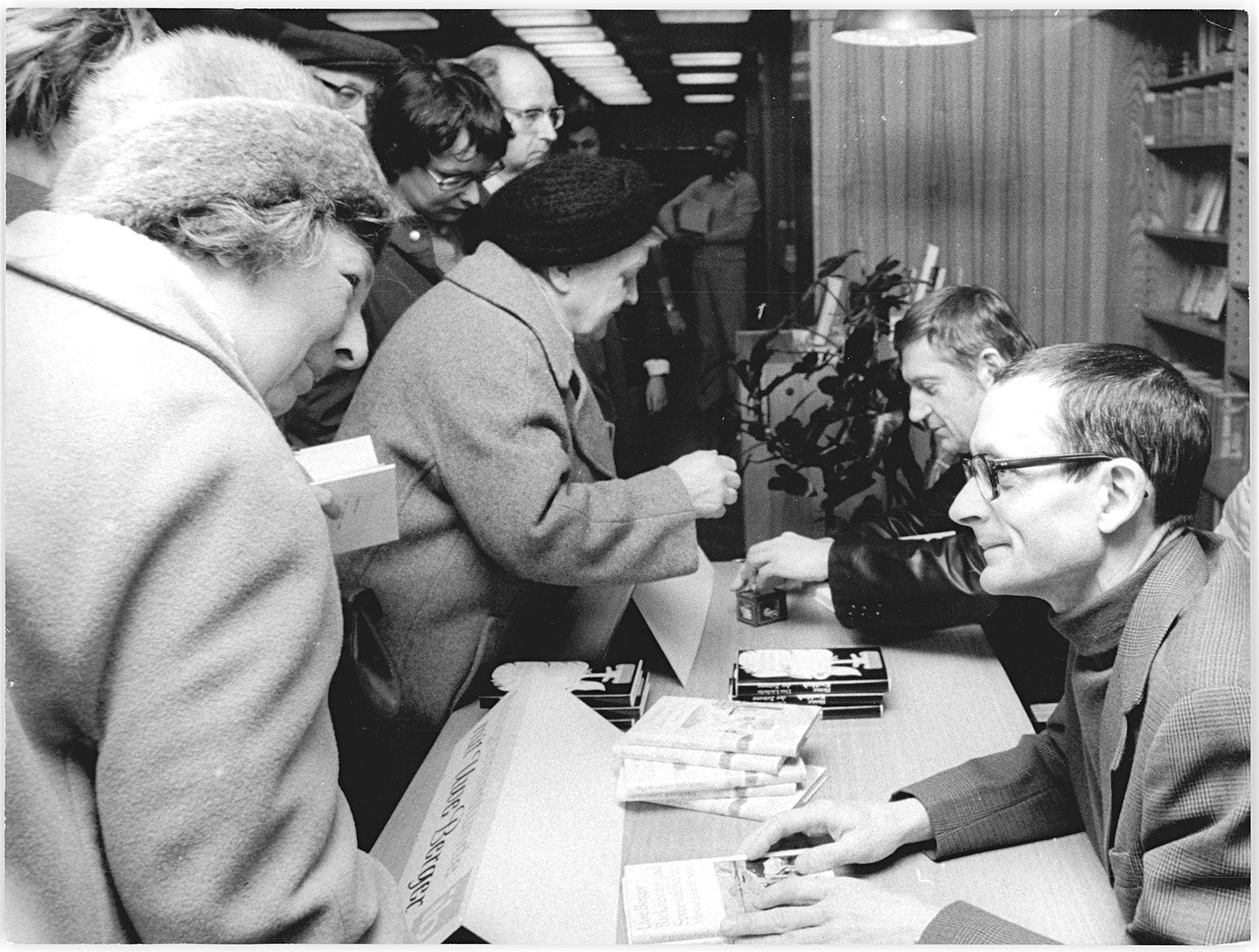 Uwe Berger, right, signing his books