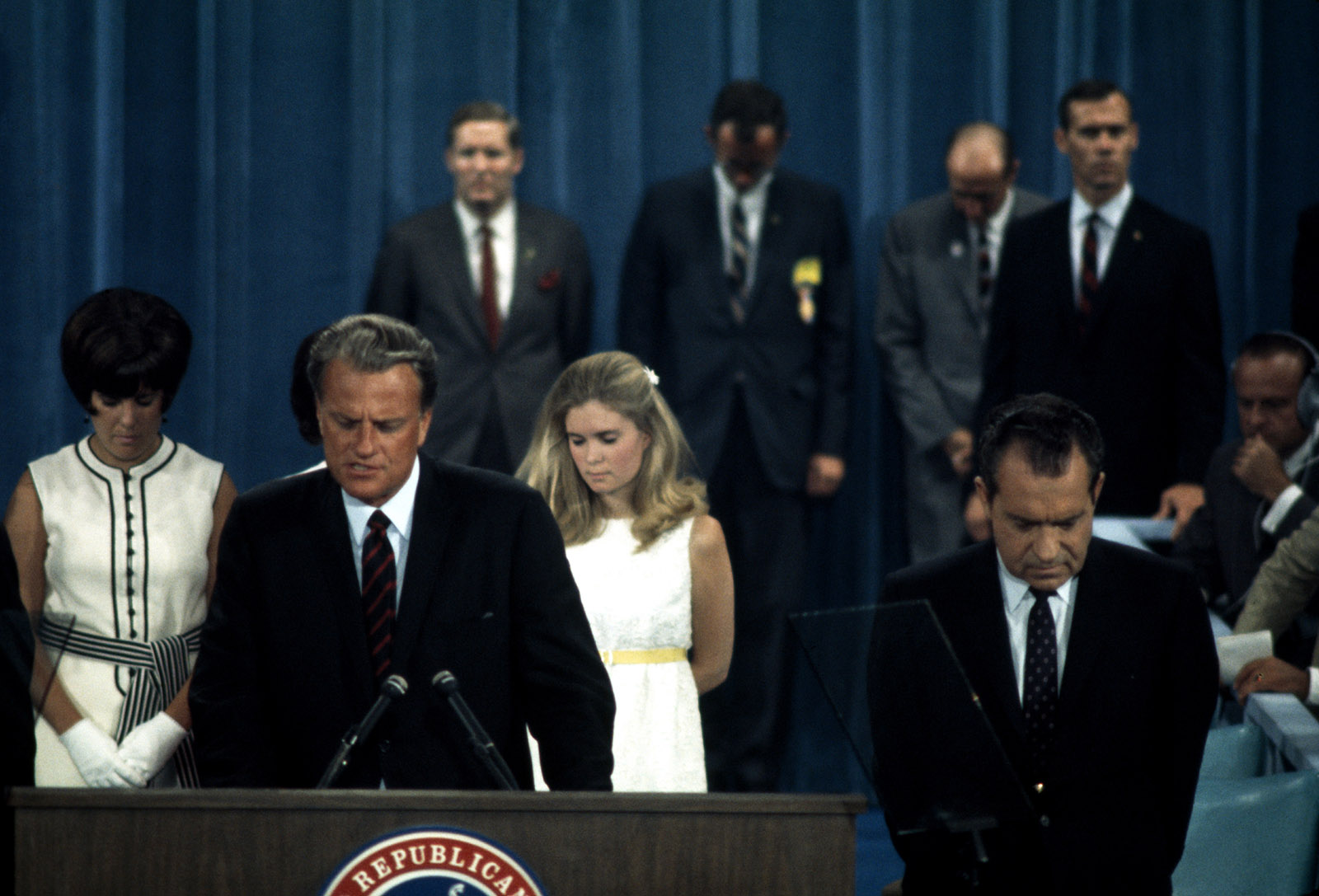 Billy Graham leading a prayer at the Republican National Convention, 1968; Richard Nixon is at right