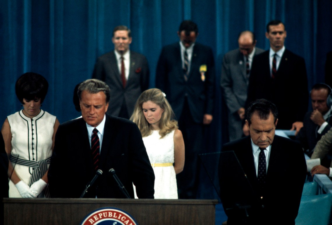 Billy Graham leading a prayer at the Republican National Convention, 1968; Richard Nixon is at right