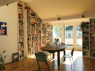 A dining room with many bookshelves