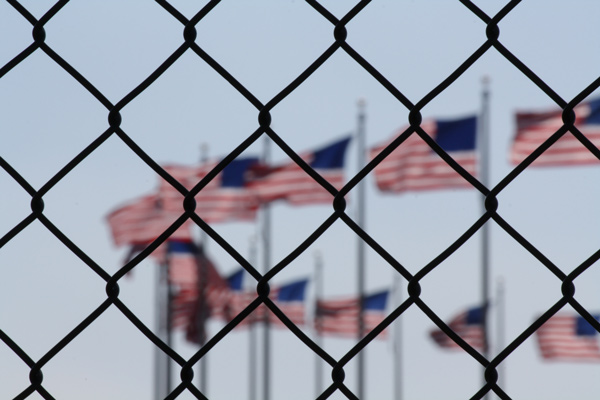 American flags behind chain link fence