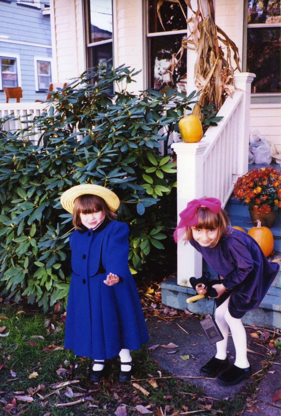 Two girls, age three and age six, dressed for Halloween as Ludwig Bemelman's Madeline and Kiki, the witch from the animated film Kiki's Delivery Service