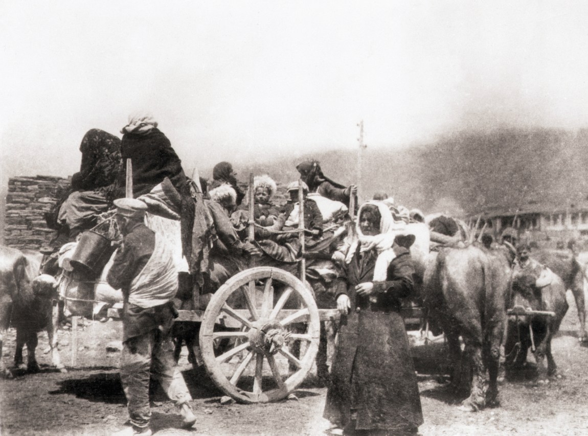 1920 Photo shows Armenian refugees fleeing the Turks. They have a number of wagons loaded with supplies.